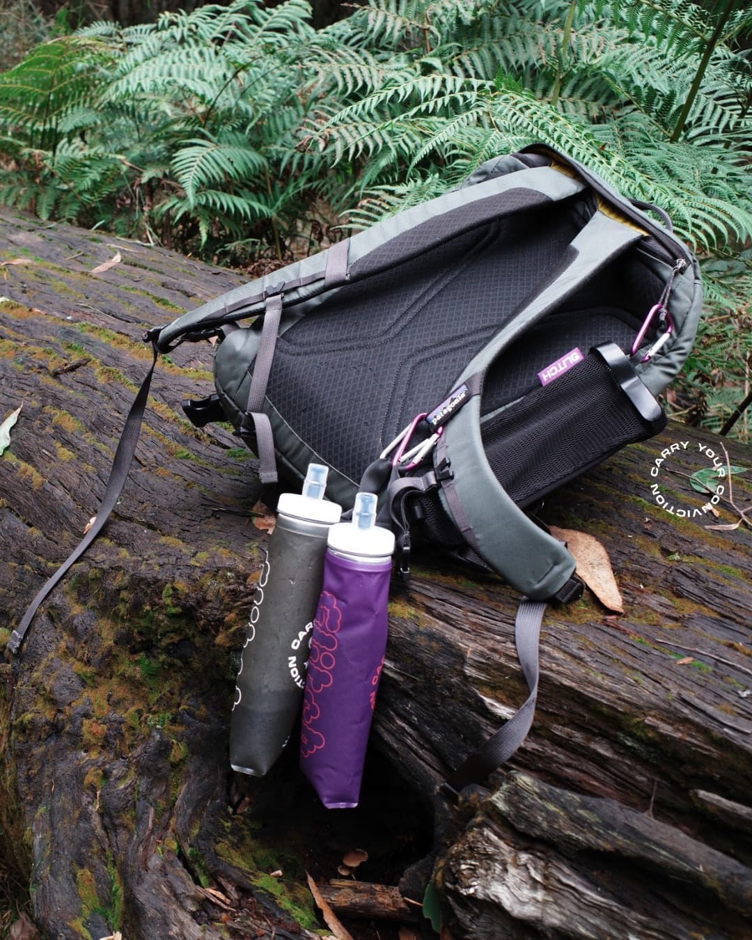 Glitch bottles resting on a mossy log