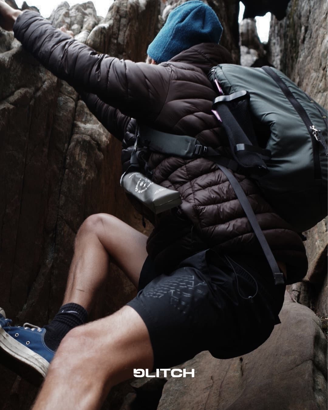 Team member scrambling over rocks with a Glitch bottle attached